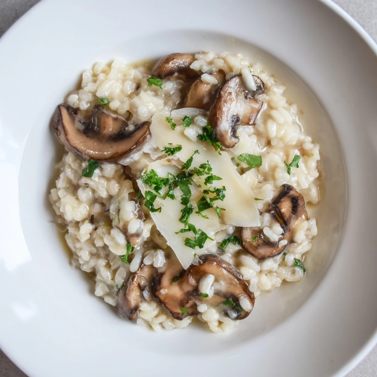 Steaming bowl of stove-top creamy risotto, a rich Italian rice dish ready to serve.