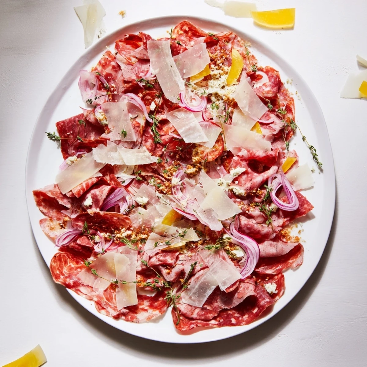 A wooden board with The Burlap & Lace charcuterie, featuring meats, cheeses, and garnishes, ready to eat.