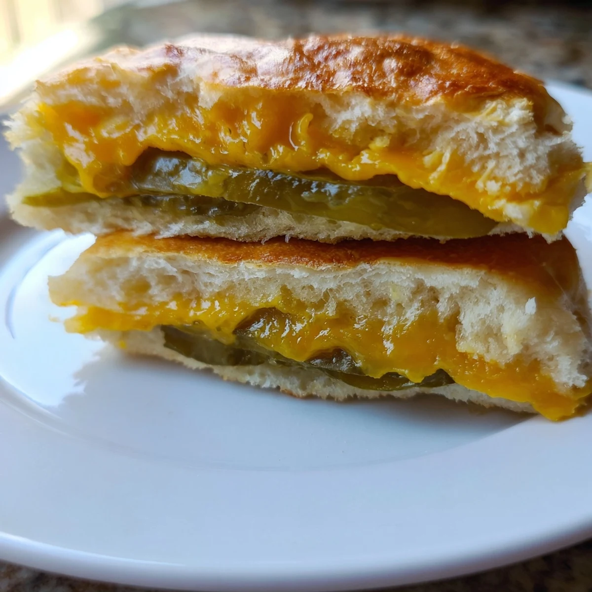 Golden, bubbly Pickle Bread Sandwich features melted cheddar and crunchy dill pickles, perfect for a quick lunch.