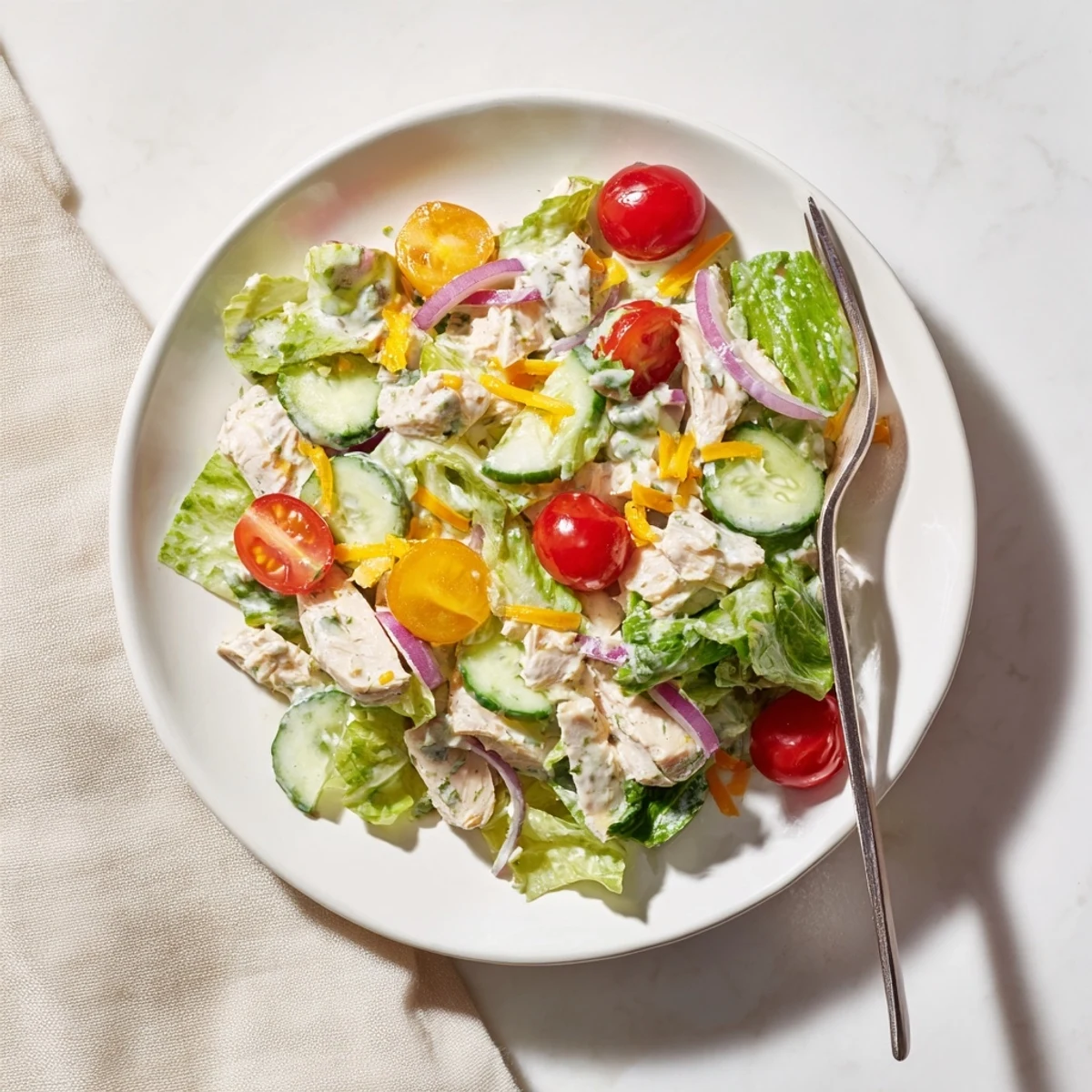 Fresh Jalapeño Ranch Chicken Salad in a rustic bowl, topped with crunchy tortilla strips and drizzled with creamy green dressing.