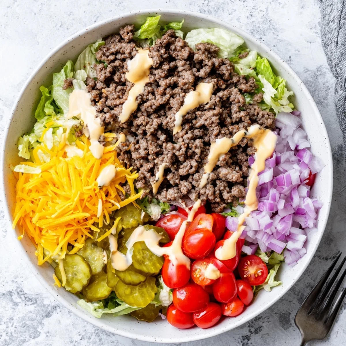 Ready-to-eat Easy Big Mac in a Bowl served in a rustic ceramic bowl, garnished with sesame seeds for a classic cheeseburger finish.