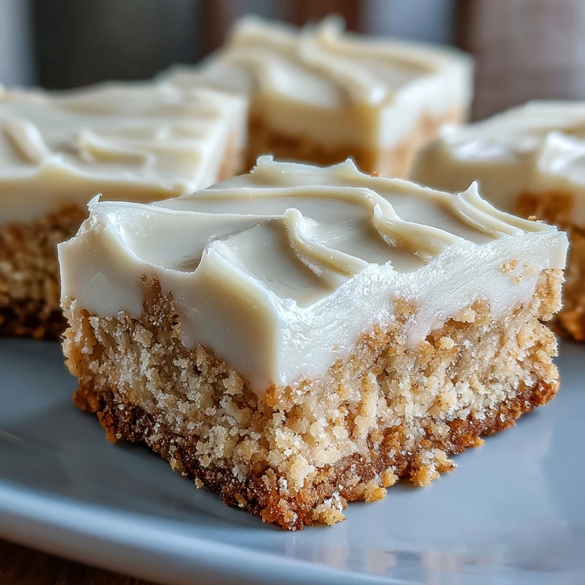 Golden-brown Almond Flour Sugar Cookie Bars with creamy frosting, ready to slice and serve as a gluten-free dessert treat.