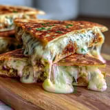 Crispy flour tortilla stuffed with creamy mashed black-eyed peas, diced onions, and cilantro, served with a side of salsa.