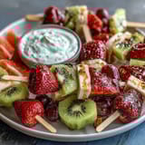 Fun Kid Lunch Bento Box with Fruit Skewers and Dip: Colorful skewers of strawberry, pineapple, and kiwi paired with creamy yogurt dip in a playful lunchbox.