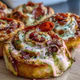 Flaky pastry pinwheels loaded with pepperoni, mozzarella, and marinara, baked until golden and bubbling.  