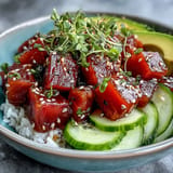 Colorful tuna poke bowl featuring crisp radish, avocado, and fluffy sushi rice.