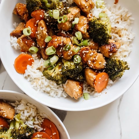 Golden-brown chicken pieces, tender rice, and vibrant green broccoli florets glisten with a sweet honey garlic sauce in this one-pan meal.