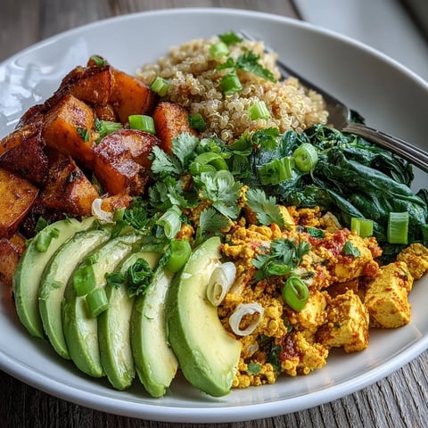 Hearty vegan Tofu Scramble Breakfast Bowl with golden roasted sweet potatoes and fluffy quinoa.