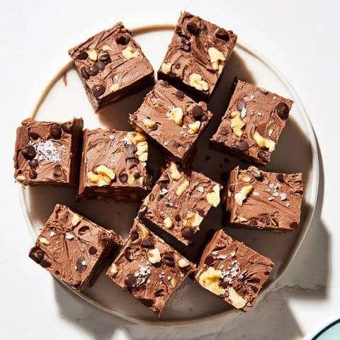 A close-up of delicious easy chocolate fudge squares, perfect for holiday gifting or dessert.