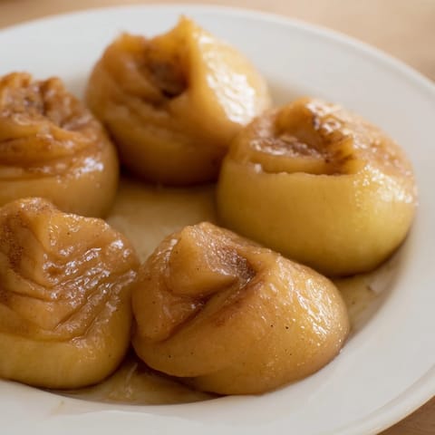 Warm, bubbling Baked Apple Slices with cinnamon and vanilla, perfect for a cozy dessert or topping.