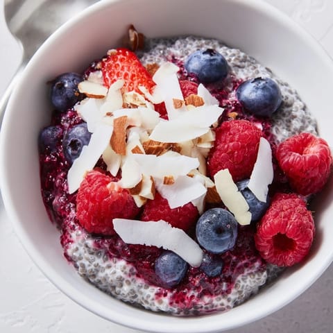 A close-up of Berry Chia Pudding with glossy berries, perfect and ready to eat cold.