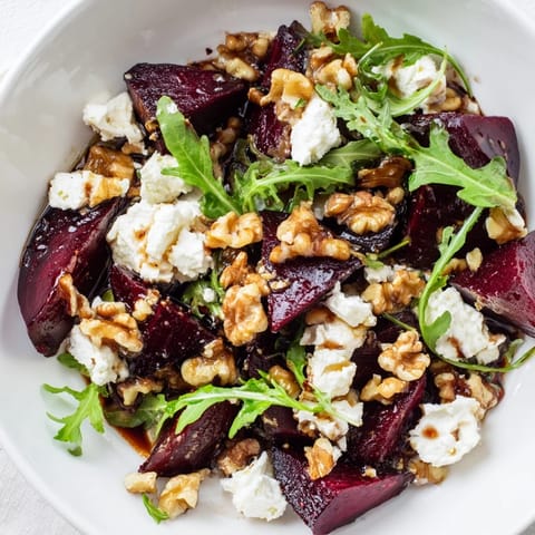 Golden roasted beets and tangy goat cheese top a bed of peppery arugula in this Roasted Beet Goat Cheese Salad.  