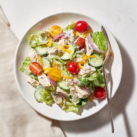Fresh Jalapeño Ranch Chicken Salad in a rustic bowl, topped with crunchy tortilla strips and drizzled with creamy green dressing.