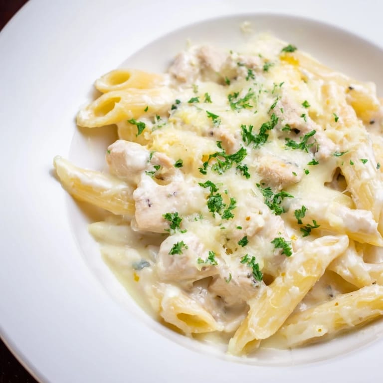 Delicious Chicken Alfredo Bake, featuring melted cheese and a rich Alfredo sauce, ready to serve and enjoy.