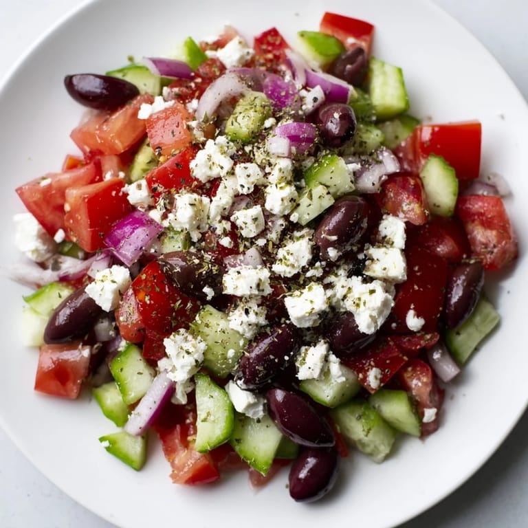 Fresh Mediterranean Salad with olives and herbs, drizzled with olive oil and vinegar.