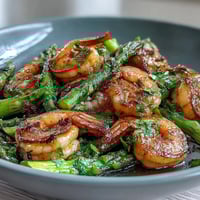 Healthy Easy One-Pan Lemon Garlic Shrimp and Asparagus with vibrant green asparagus spears, juicy shrimp, and golden garlic, roasted to perfection and drizzled with fresh lemon.